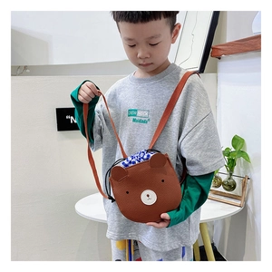 Close-up of brown bear crossbody bag for kids featuring textured leather and drawstring closure
