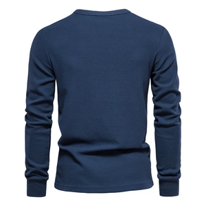 Detail view of navy blue waffle knit texture on men's long sleeve crewneck shirt