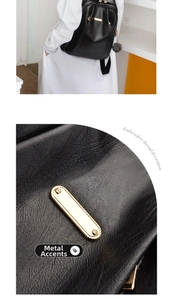 Detail of lychee pattern leather texture with gold hardware decoration and pompom charm
