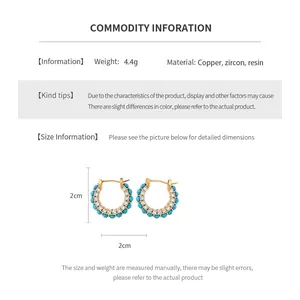 Detailed size view of vintage gold plated earrings with zircon and resin inlay