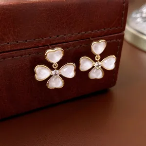 Elegant gold plated flower heart earrings with cat eye stones and sparkling crystals