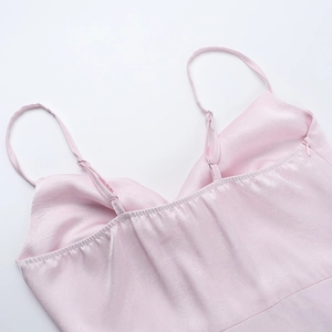 Detail view of pink satin dress featuring adjustable straps and invisible zipper seam