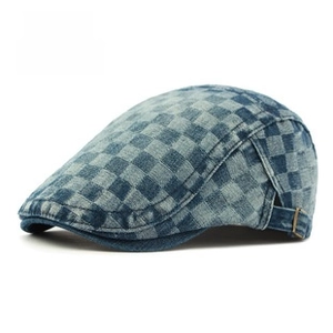 Close-up of blue and white checkered washed denim beret with adjustable metal buckle