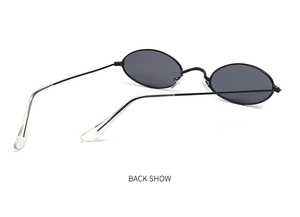 Detailed back view of vintage oval sunglasses featuring a thin black metal frame and dark lenses