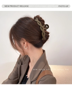 Close-up of a matte dark hair claw clip securing a twist hairstyle on a female model