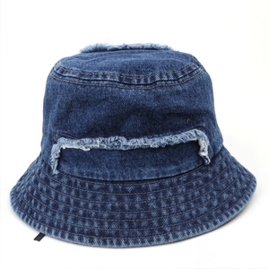 Detail of frayed edges and distressed holes on a vintage dark blue denim bucket hat