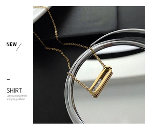 Detail of 18K gold-plated necklace featuring a rectangle pendant with three clear zircons