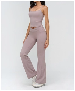 Detail of flared yoga pants featuring a stylish criss-cross V-waist and handy side pockets
