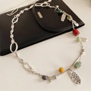 Vintage bohemian beaded necklace with metal leaves and colorful ceramic charms