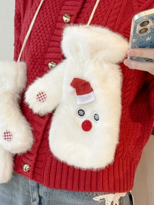 Detail of plush snowman mittens with red hat and hanging cord on red knit sweater