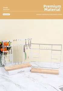 Detail view of tiered jewelry display stand with wooden base and metal hooks for earrings