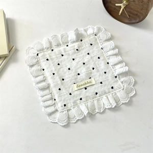 Macro view of white heart pattern fabric with multi-layered embroidery lace trim