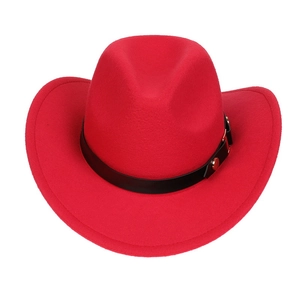 Detail of red cowboy hat with black leather band and golden metal buckle accents