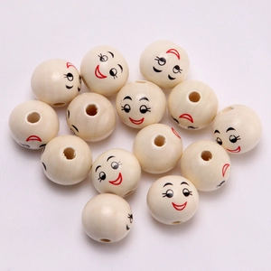 Macro shot of 20mm natural wooden beads with black and red smiley faces for crafts