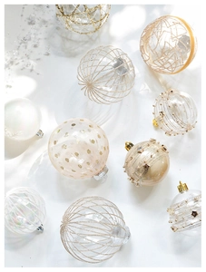 Close-up of champagne lace and pearlescent polka dot Christmas tree hanging ornaments