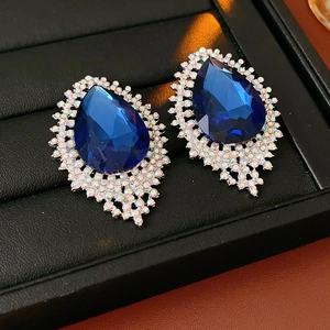 Macro shot of French vintage drop earrings with deep blue gemstones and white crystals