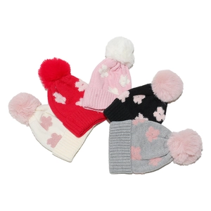 Winter knitted hats for toddler girls featuring fluffy pom-poms and flower star patterns