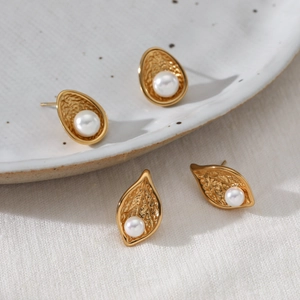 Textured gold stainless steel stud earrings with pearls in leaf and teardrop shapes