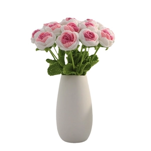 Handmade crochet rose bouquet in white ceramic vase with pink and white knitted petals