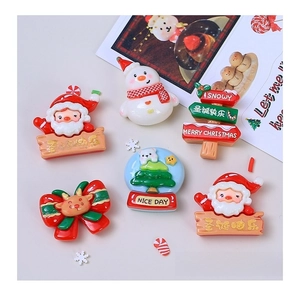 Macro detail of Christmas resin charms featuring Santa, snowmen, and festive elements