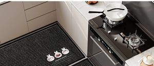 Detail of black non-slip kitchen mat with cartoon rabbit and absorbent texture surface