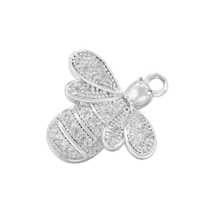 Macro shot of a silver bee pendant with pave-set crystal details for DIY jewelry making
