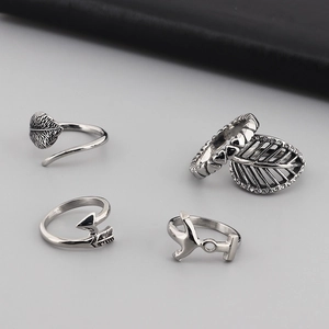 Set of four silver stainless steel rings featuring leaf and Cupid arrow designs