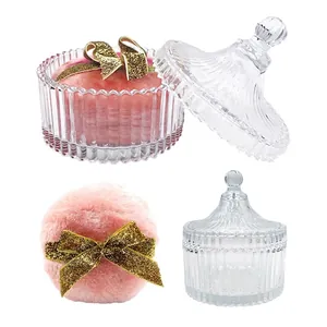 Vintage glass jar with pink plush puff and golden bow for powder storage and makeup