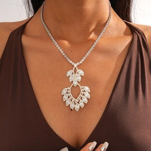 Detailed close-up of sparkling zircon teardrop pendant on a silver-plated snake chain