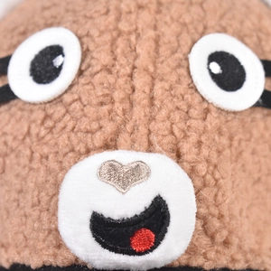 Macro detail of cartoon puppy eyes and heart nose on lamb wool plush baseball cap