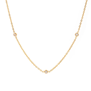 Elegant gold chain necklace featuring three bezel-set round clear gemstones on white background