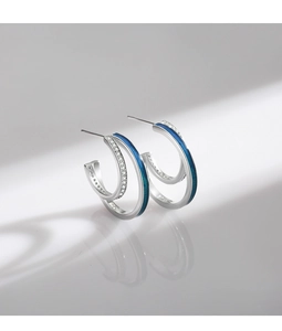 Detail of silver S925 earrings with blue enamel and micro-pave zircon crystals