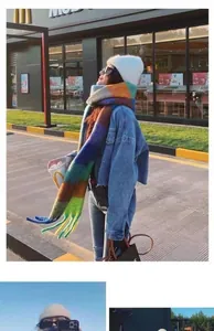 Detailed close-up of thick rainbow plaid scarf with long tassels and soft knit texture