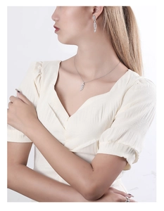 Detailed close-up showing the S925 silver leaf necklace and matching earrings on a model