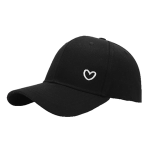 Classic black cotton baseball cap featuring delicate white heart embroidery on the side