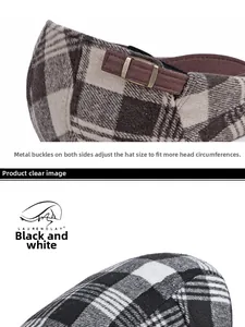 Detail view of the metal adjustable buckle on a thick British style plaid beret cap