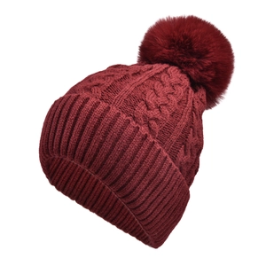 Detailed knit pattern on dark red beanie with soft faux fur pom pom decoration