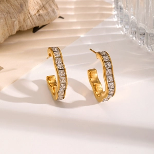 Gold-plated C-shaped hoop earrings with square-cut cubic zirconia in a modern design