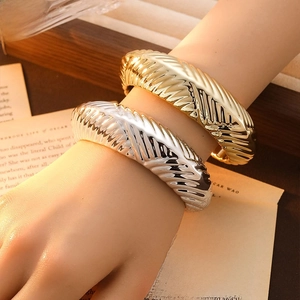 Thick ribbed metal open bracelets in gold and silver finish with retro industrial style