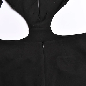 Detail of a black backless dress with a cutout waist and hidden zipper closure