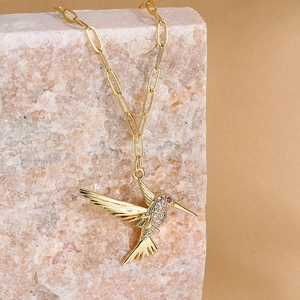 18K gold plated hummingbird necklace featuring pavé zircon and red gemstone eye detail