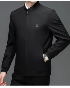 Detail of black stand collar jacket featuring precise logo embroidery and rib-knit cuffs