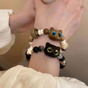Detail of beaded cat bracelets featuring cute cat heads and star charms on the wrist