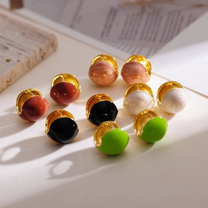Detailed macro view of retro gold-plated earrings with colorful marble oil drip beads