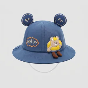 Detailed close-up of blue cotton bucket hat with bear ears and adjustable windproof cord