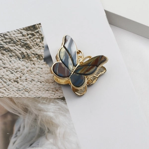Detail of vintage double-layer enamel butterfly hair claw clip with golden alloy teeth