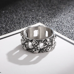 Close-up of punk style silver skull ring featuring hollowed-out vintage Cuban chain texture