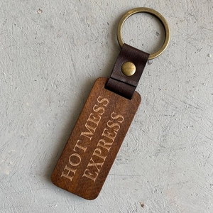 Vintage wooden keychain with American flag style leather loop and Hot Mess Express engraving