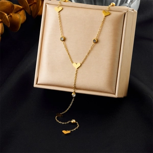Detail of gold-plated Y-shaped necklace with heart charms and white cubic zirconia