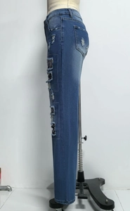 Detailansicht der blauen Jeans mit Totenkopf-Patch und modischem Ripped-Design
